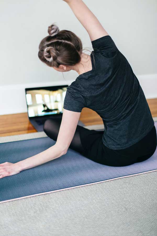 Woman taking online yoga class